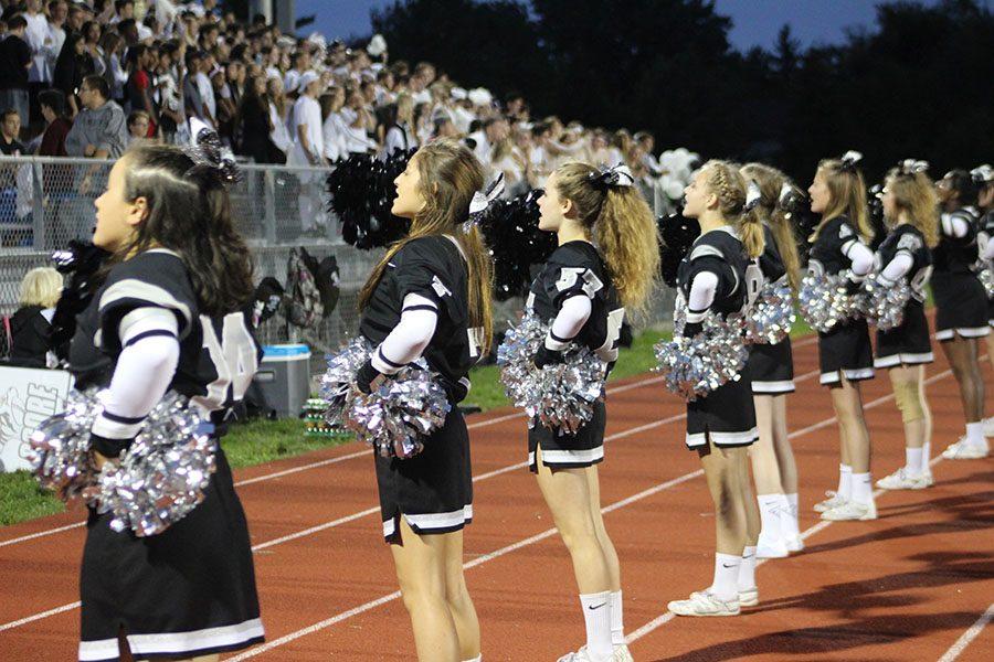 The cheerleaders in front of the student section help keep up the school spirit as Churchill gets ahead during Plymouths Homecoming game.