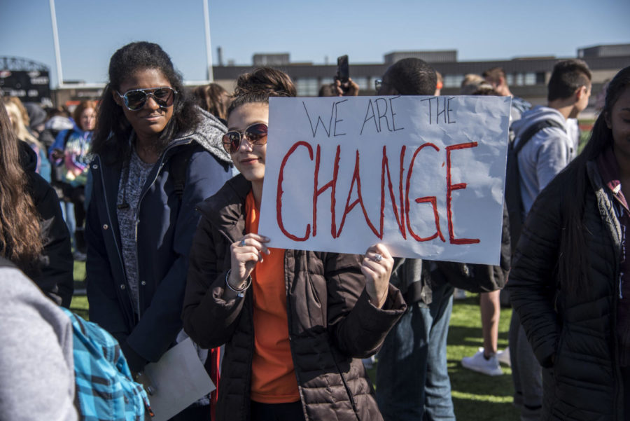 Canton senior Genevieve Graham proudly holds up her sign saying, We are the change. 