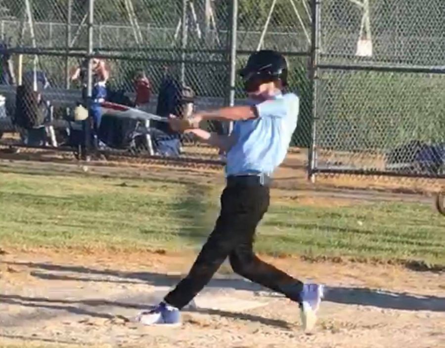 Michigan Blue Jays player and Pioneer student Lucas Galante swings his bat to make contact with the oncoming pitch.
