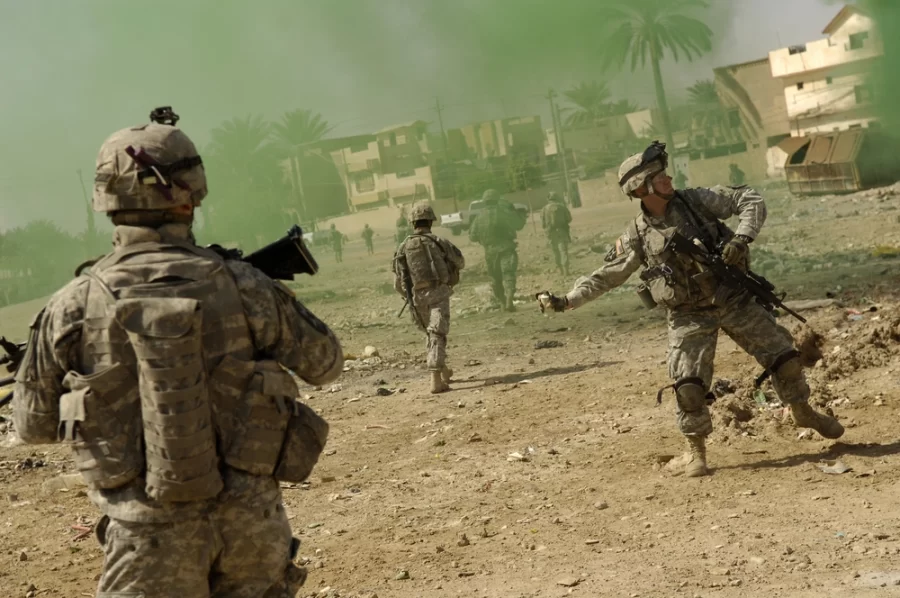 U.S.+Army+Sgt.+Bill+Stachler+throws+a+smoke+grenade+to+mask+his+teams+movements+during+a+joint+operation+with+the+Iraqi+police+in+Baqubah%2C+Iraq%2C+March+31%2C+2007.+The+purpose+of+the+operation+is+to+clear+houses+and+palm+groves+near+the+Diyala+River+of+any+insurgent+forces.+Stachler+is+with+the+5th+Battalion%2C+20th+Infantry+Regiment.+