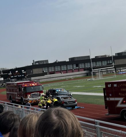 The Canton Fire Department removes a student actor from a destroyed car located in the P-CEP East Turf Stadium. May 11, 2022. 