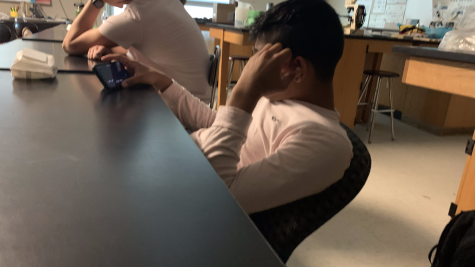 Krishna Patel, Plymouth Senior, on his phone while class is going on. May 12, 2022.
