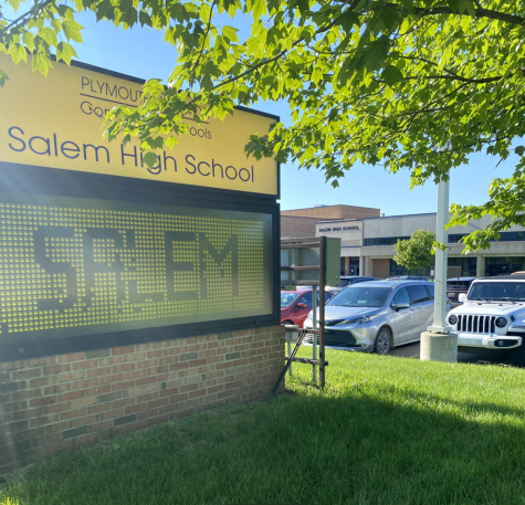 The sign identifying the accompanying building as Salem High School stands in front of the school on a sunny morning. June 3, 2022. 