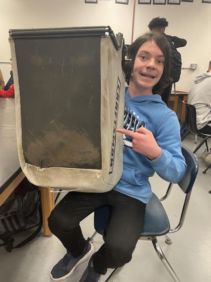 Lawncare at its finest: Kyle Frew, Canton sophomore, uses a lawnmower bag to transport school supplies. October 13, 2022. 