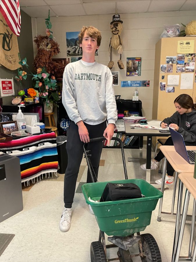 Noah Knutsen, Plymouth senior, uses a rock salt spreader to bring his materials to Spanish class. October 13, 2022.
