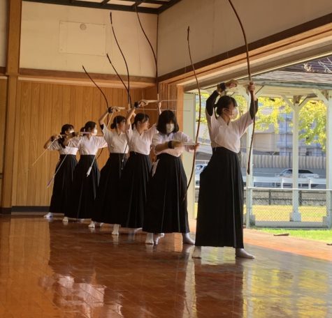 Kwassui High School students of various grade levels raise their bows, which are also known as yumi. October 3, 2022. 