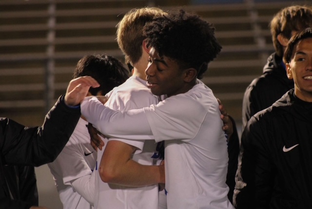 Foster Garrett, Salem senior, embraces his teammate after their 1-0 win against Saline in the division 1 regional final game. October 27, 2022.