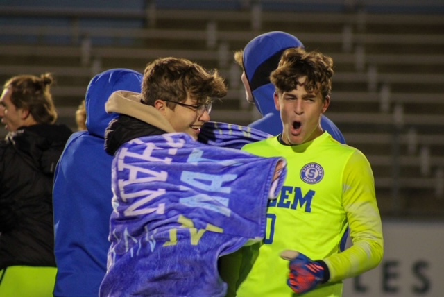 Goalkeeper Tommy Veresh, Salem junior, celebrates with friends after the 1-0 victory at Ann Arbor Skyline HIgh School. October 27, 2022
