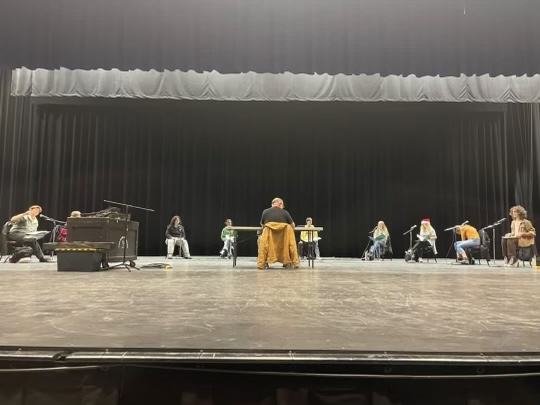 The cast members prepare to read the audio recording script of “A Christmas Carol” on the stage inside of the Gloria Logan Auditorium at Salem High School. November 29, 2022.