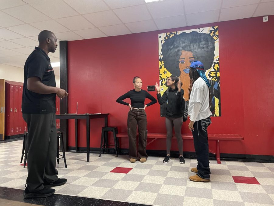 Vernon Crump, Canton assistant principal; Nylah Brown, Plymouth junior; Nadia Kreft, Salem junior; and Jaden Green, Salem junior; rehearse their lines before recording their promotional video for the African American History & Culture class. December 20, 2022. 