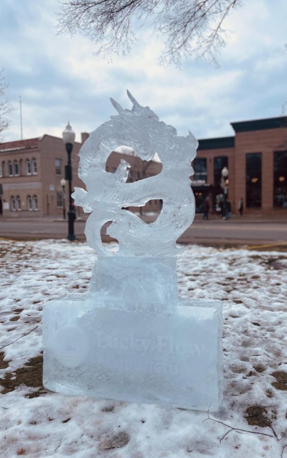 A dragon breathes fire in Lucky Flow Acupunture’s ice sculpture at the ice festival in downtown Plymouth, Michigan. February 1, 2023. 