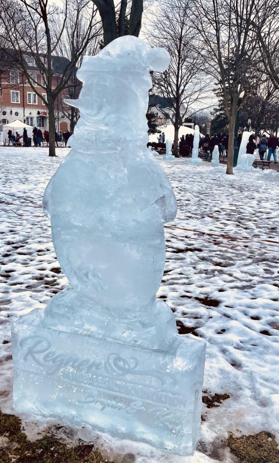 An ice sculpture of a snowman stands in Kellogg Park in downtown Plymouth in festive winter attire as visitors walk around to look. February 1, 2023. 