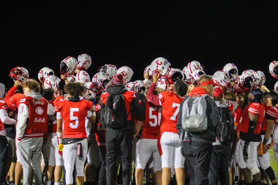 Canton Varsity Football Team coming together in a huddle at the P-CEP Varsity Stadium.