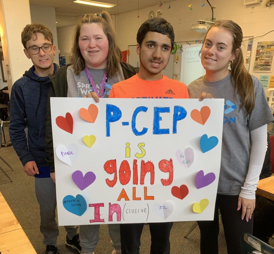 Connor Lucas, Salem sophomore, Delaney Israel, Salem sophomore, Vikas Manikkara, Canton junior, and Peyton Battistelli, Plymouth senior hold a poster which reads “P-CEP is going all in(clusive)” as part of the Spread the Word campaign. Salem High School, March 1, 2023. 