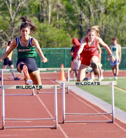 Rinaldi leaps over a hurdle during her race at the KLAA Championsip meet at Novi High School on May 13, 2022. 