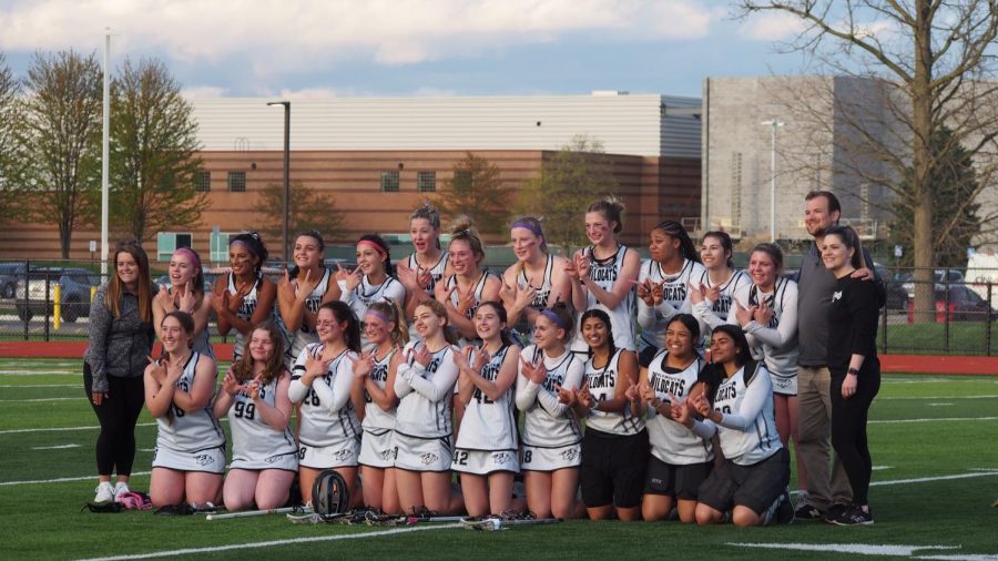 The+Plymouth+Girls+Varsity+Lacrosse+team+poses+and+forms+a+%E2%80%9CW%E2%80%9D+with+their+hands+after+defeating+Salem.+May+4%2C+2023.