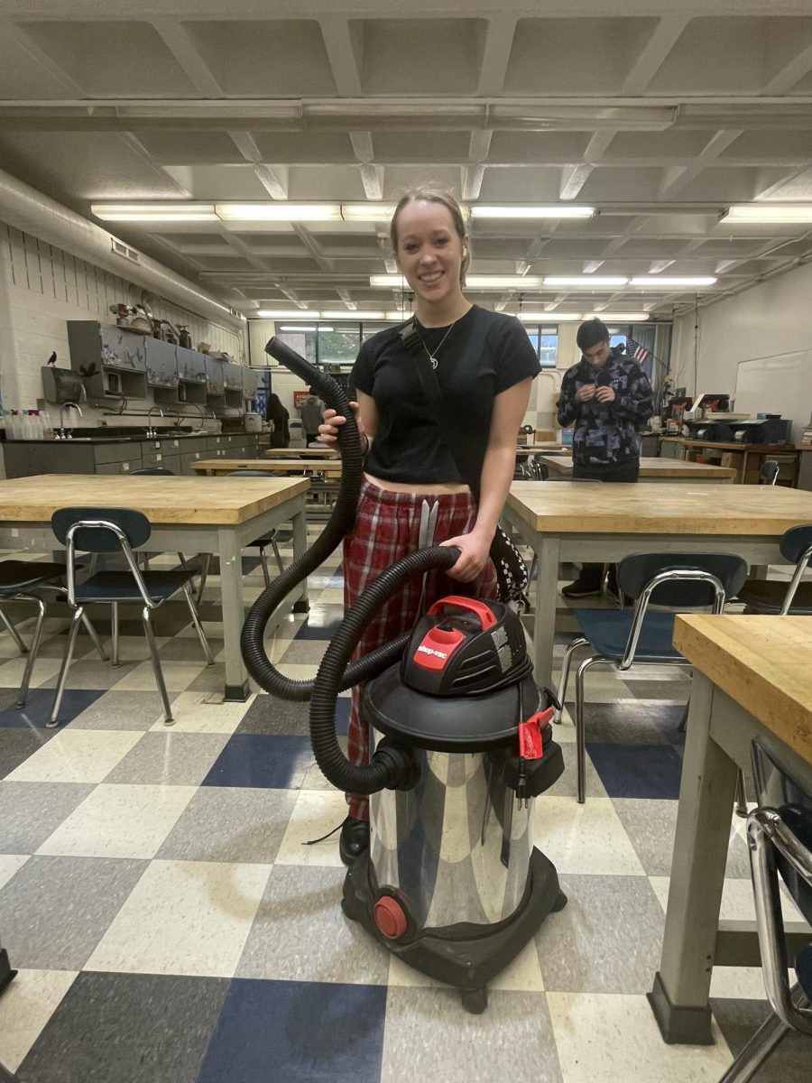 Amelia Rugh, Canton senior, is ready to clean up with her vacuum backpack during art class. Sept. 20, 2023. 
