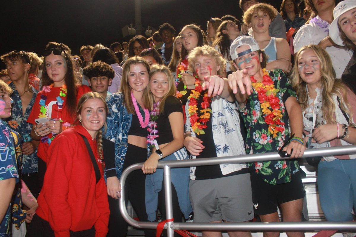 The+P-CEP+Student+Section+sports+beach+themed+outfits+as+they+cheer+on+Canton+Varsity+Football.+September+29%2C+2023.+