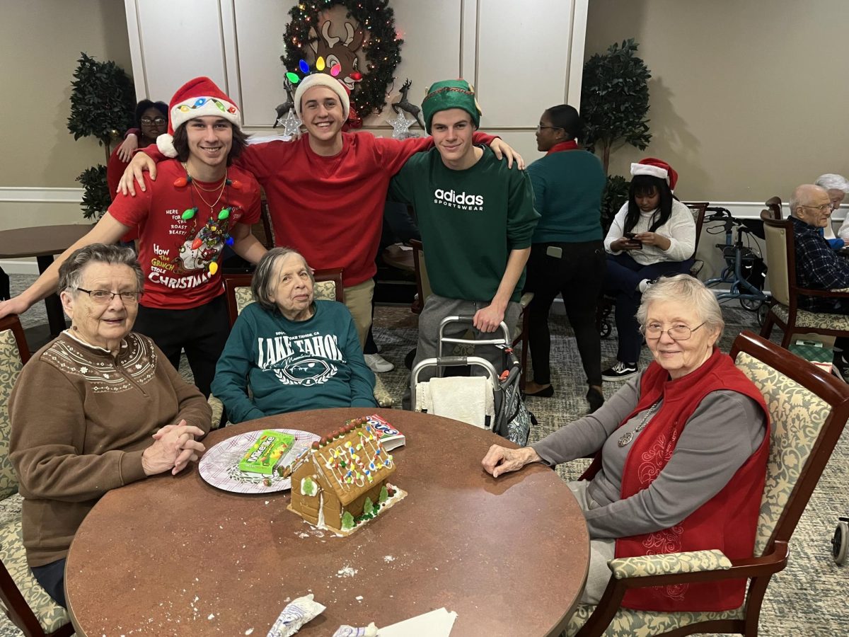 Giving Heart members and Independence Village residents display their decorated gingerbread house. December 16, 2023. 