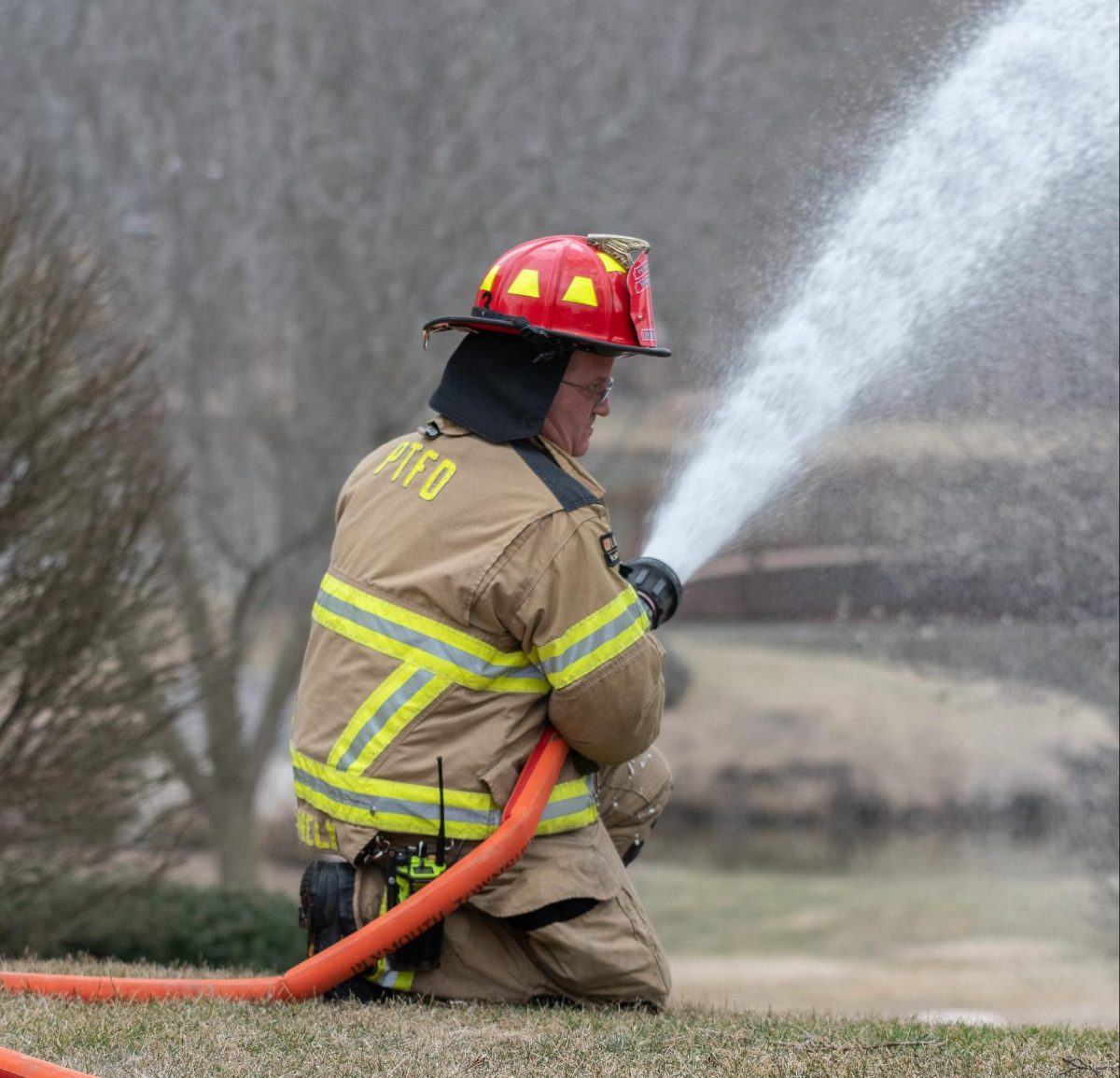Patrick Conely uses a fire hose to put out a residential structure fire in Plymouth Township. 2022