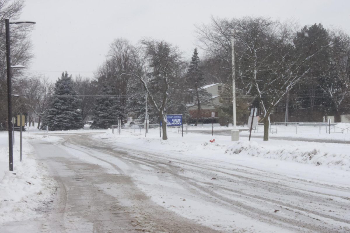 The Salem student parking lot entrance from Joy Road in Canton, Mich., is covered in snow that accumulated throughout the school day, following a snowstorm from Jan. 15 to Jan. 17, 2024, which resulted in over 7 inches of snow. Jan. 18, 2024.