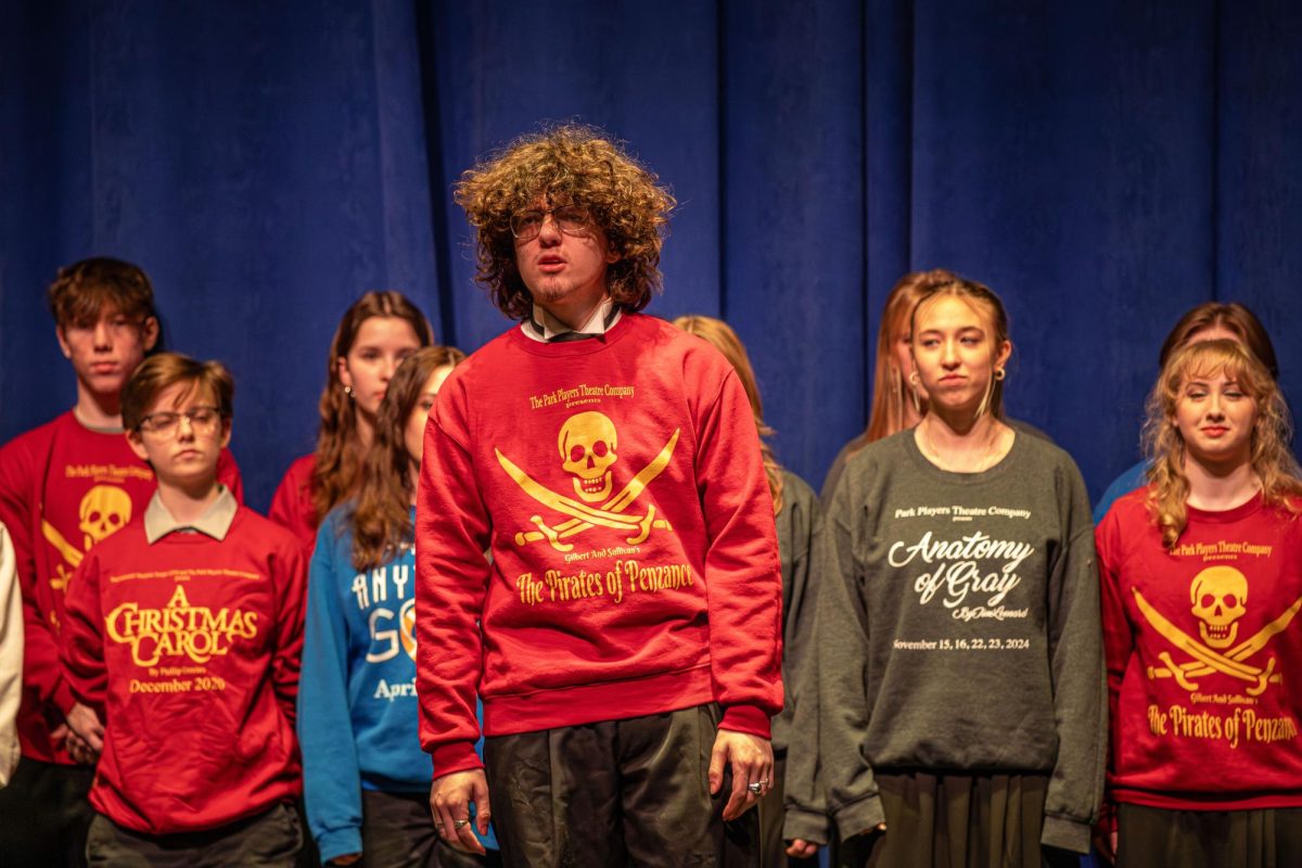 Canton senior Aidan Dillon sings “I’ll Go Home with Bonnie Jean” from The Park Players Theater Company’s spring musical “Brigadoon” while the ensemble cast sings backup at the Collage Concert held in the Gloria Logan Auditorium at Salem High School, Feb. 5, 2025.