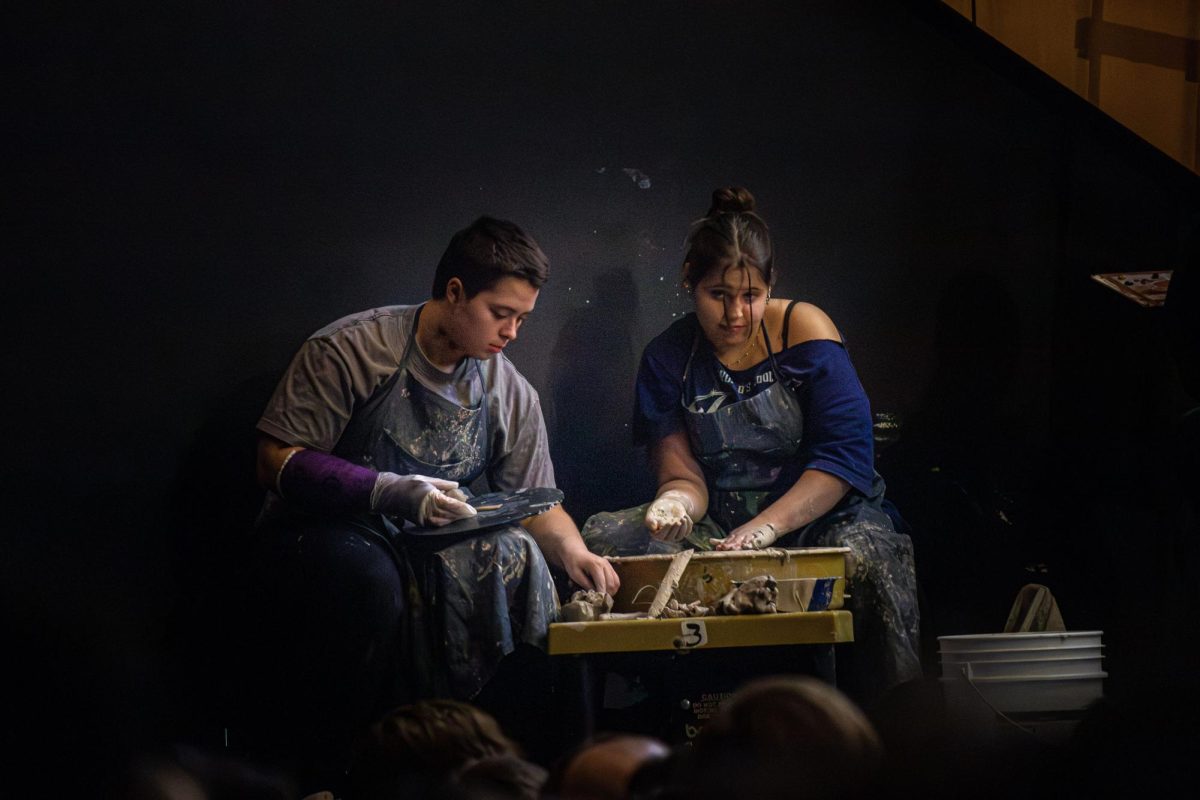 Canton senior Bella Kanaan (left) and Plymouth senior Sydney McComb (right) create ceramic pottery live for the eighth graders attending the Collage Concert held in the Gloria Logan Auditorium at Salem High School, Feb. 5, 2025.