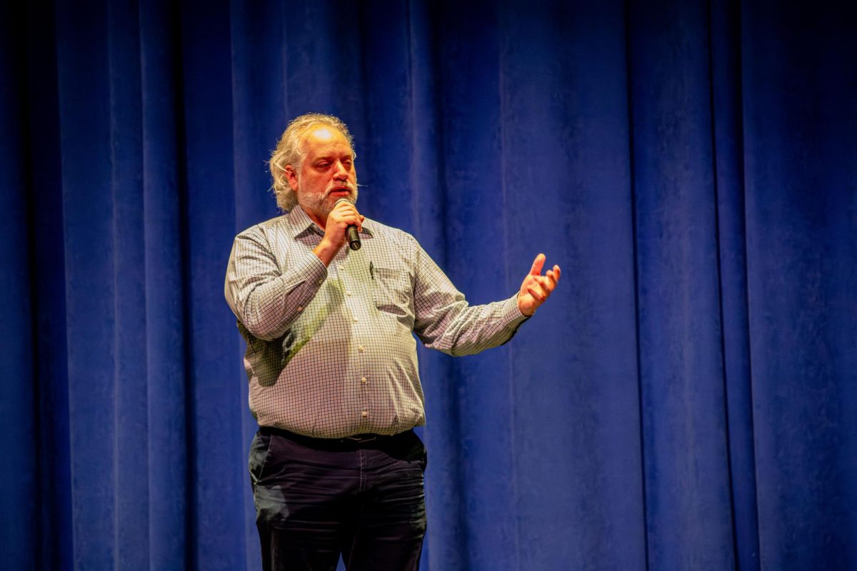 Jonathan Lunneberg, P-CEP choir director, introduces the P-CEP choir group Encore! at the Collage Concert held in the Gloria Logan Auditorium at Salem High School, Feb. 5, 2025.