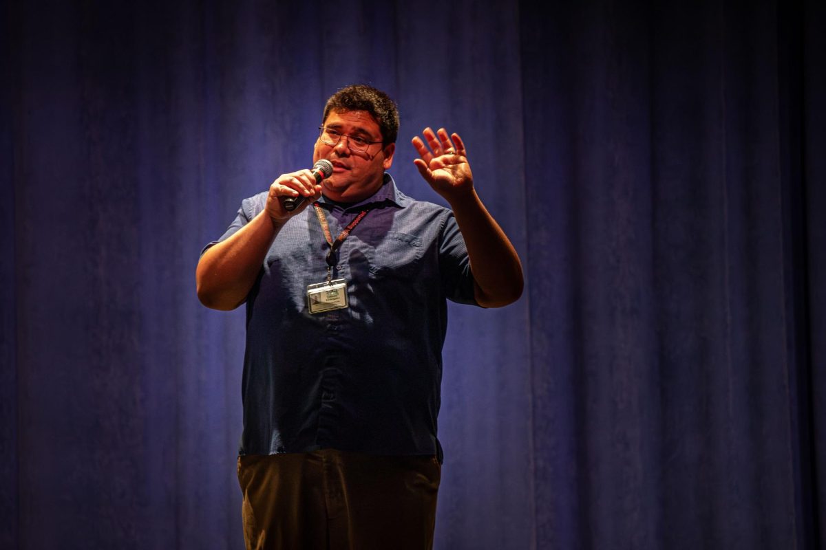 Michael Wells, Plymouth music teacher, announces the P-CEP Wind Ensemble, and receives the loudest applause of the event when he says the group will be playing music from the movie “Wicked” at the Collage Concert held in the Gloria Logan Auditorium at Salem High School, Feb. 5, 2025.