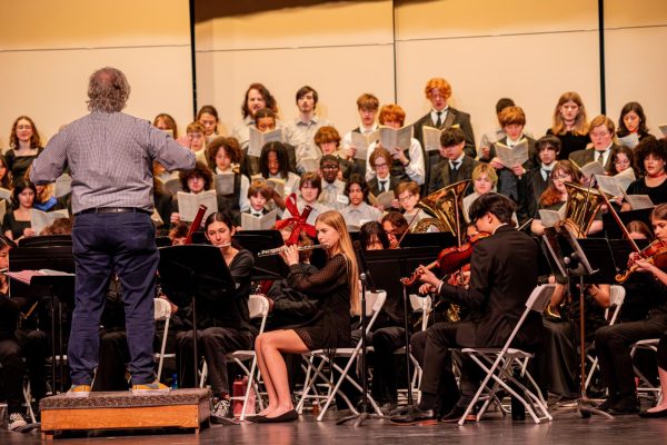 Salem choir director Jonathan Lunneberg conducts students as they play “O Fortuna” by Carl Orff for the finale at the Collage Concert held in the Gloria Logan Auditorium at Salem High School, Feb. 5, 2025.