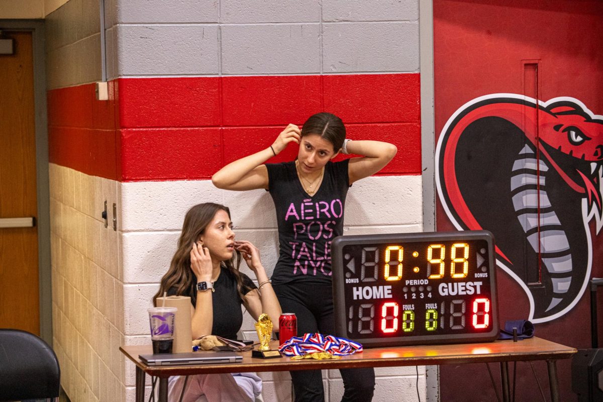 Canton seniors Somer Qureshi (left) and Sofia Qureshi (right) operate the clock at the Powderbuff Tournament, March 7, 2025.