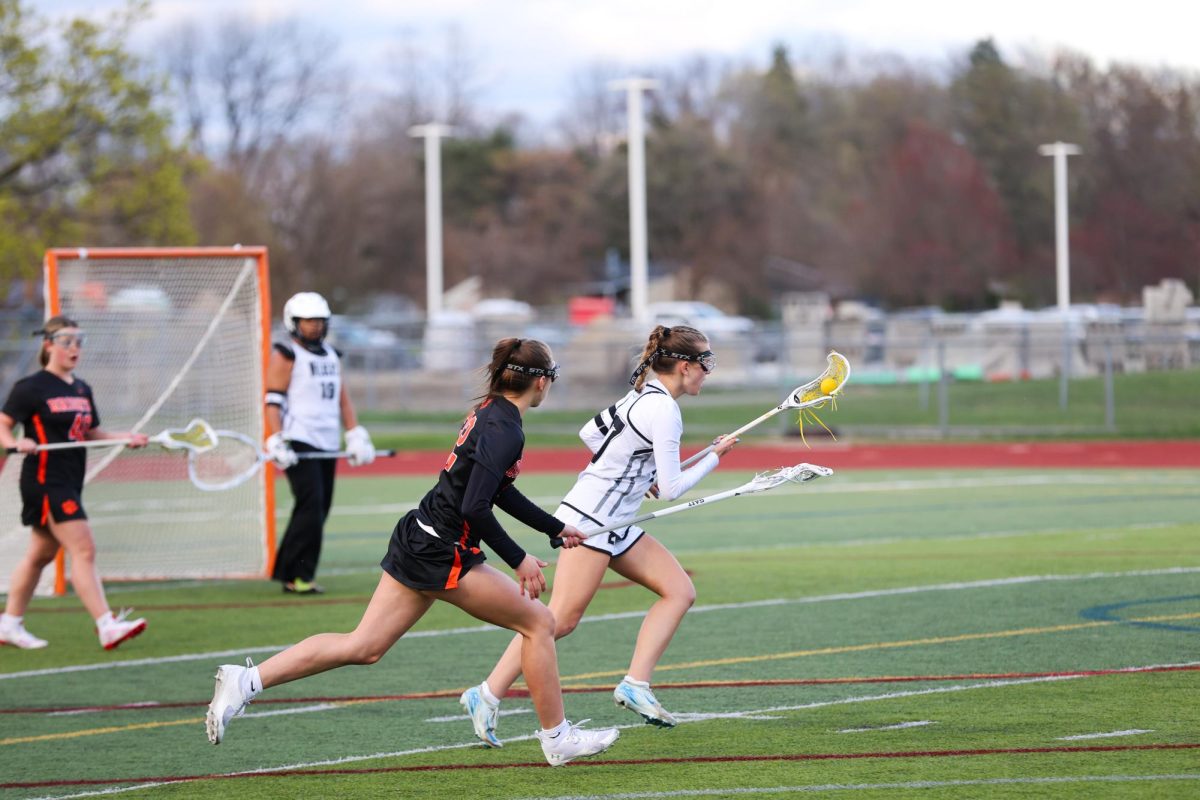 Jaclyn Schlanser crosses the field with the ball in her crosse during a game against Brighton. April 21, 2025. 