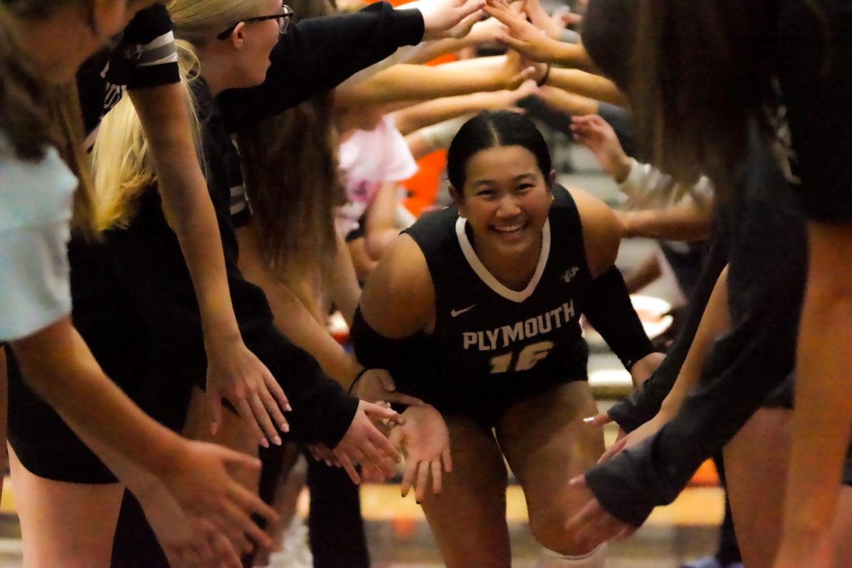 Before the game, sophomore Hope Purwadihardja runs through the tunnel of high-fives to get energized. October 7, 2025.