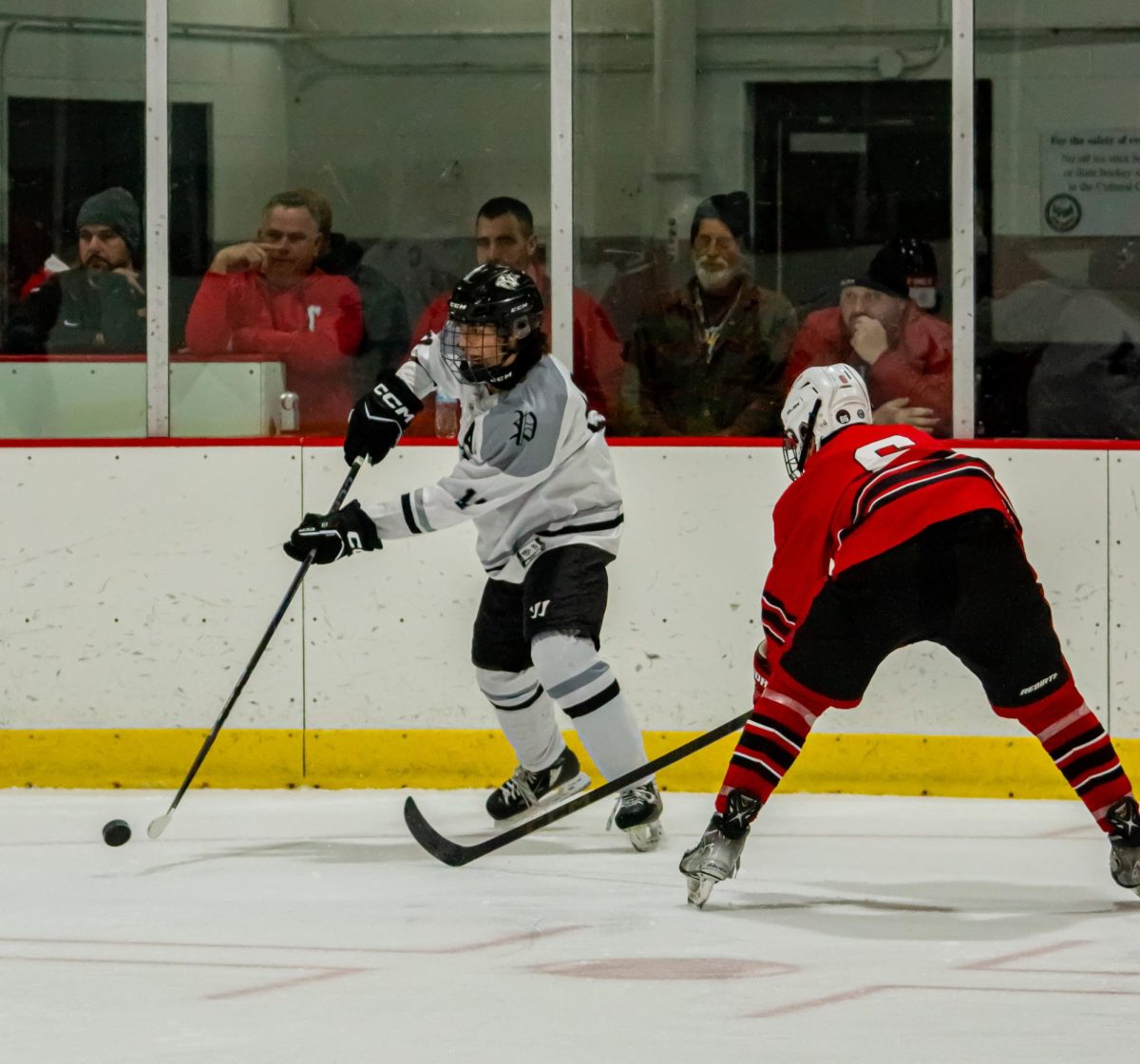 Plymouth senior Adrian Clarke goes in for the shot, while Canton junior Will Schley defends. November 25, 2025.
