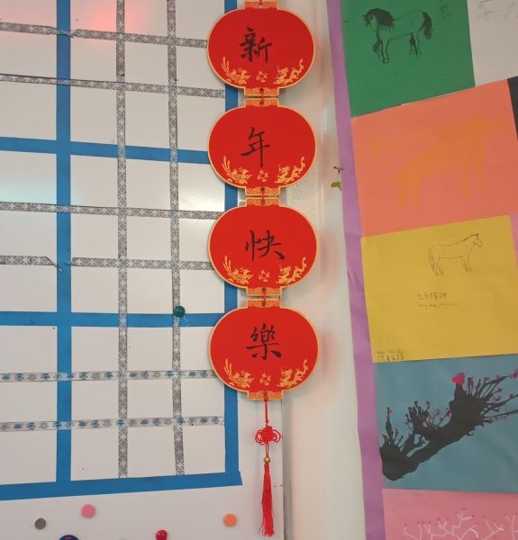 A sign hangs near the front of the classroom of Canton Mandarin Chinese teacher, Li Zhang, which says, Xínnián Kuàlè  (新年快乐: Happy New Year). January 30, 2026.