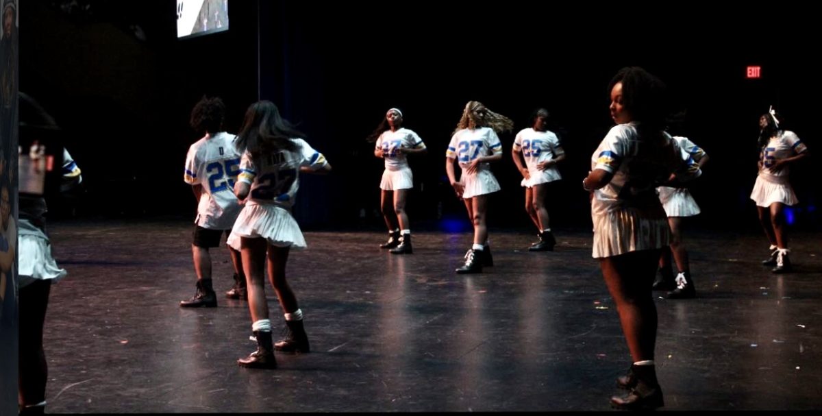 The Step team performs during the 2025 HBCU homecoming-themed Black Student Union showcase in the Salem auditorium, sporting white jerseys and tennis skirts. Feb. 27, 2025. 