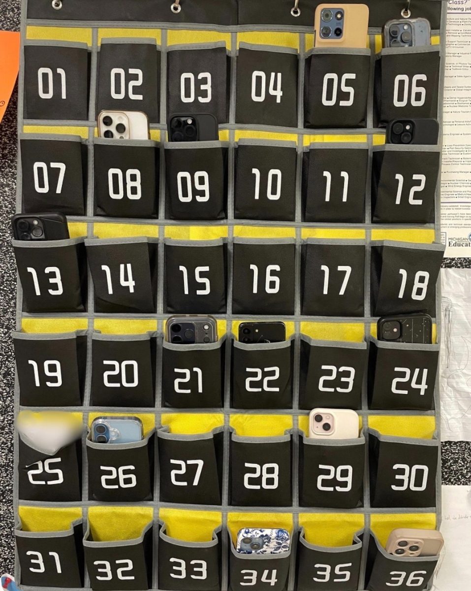 Phones sit in a numbered caddy during instructional time in a Canton High School classroom. Feb. 5, 2026.
