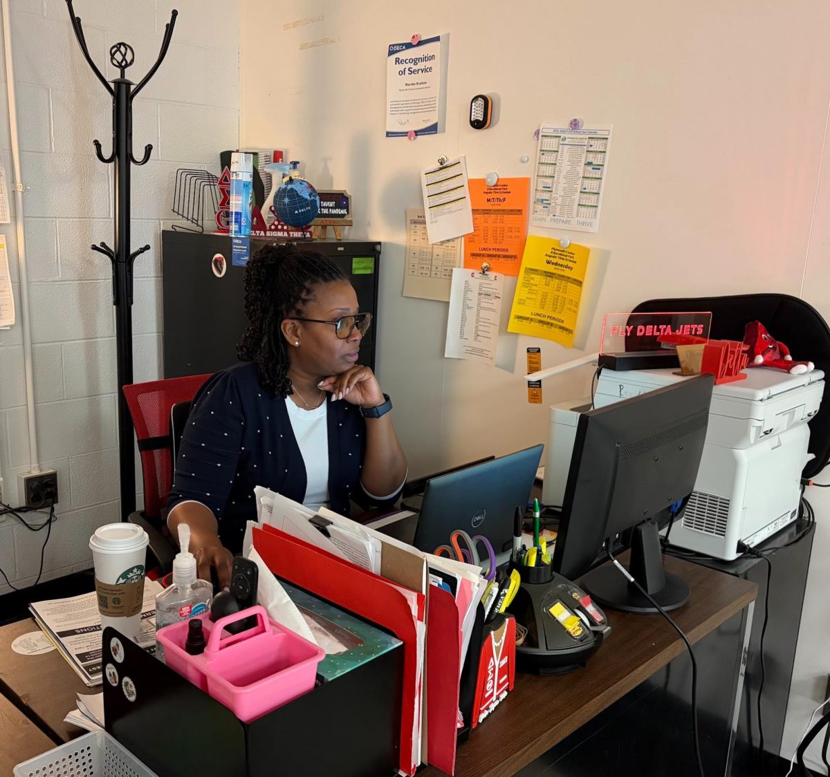 Canton CTE teacher Marsha Watkins sits behind her desk decked with Delta Airlines and Delta Sigma Theta Sorority paraphernalia as she prepares for her classes. April 24, 2026. 