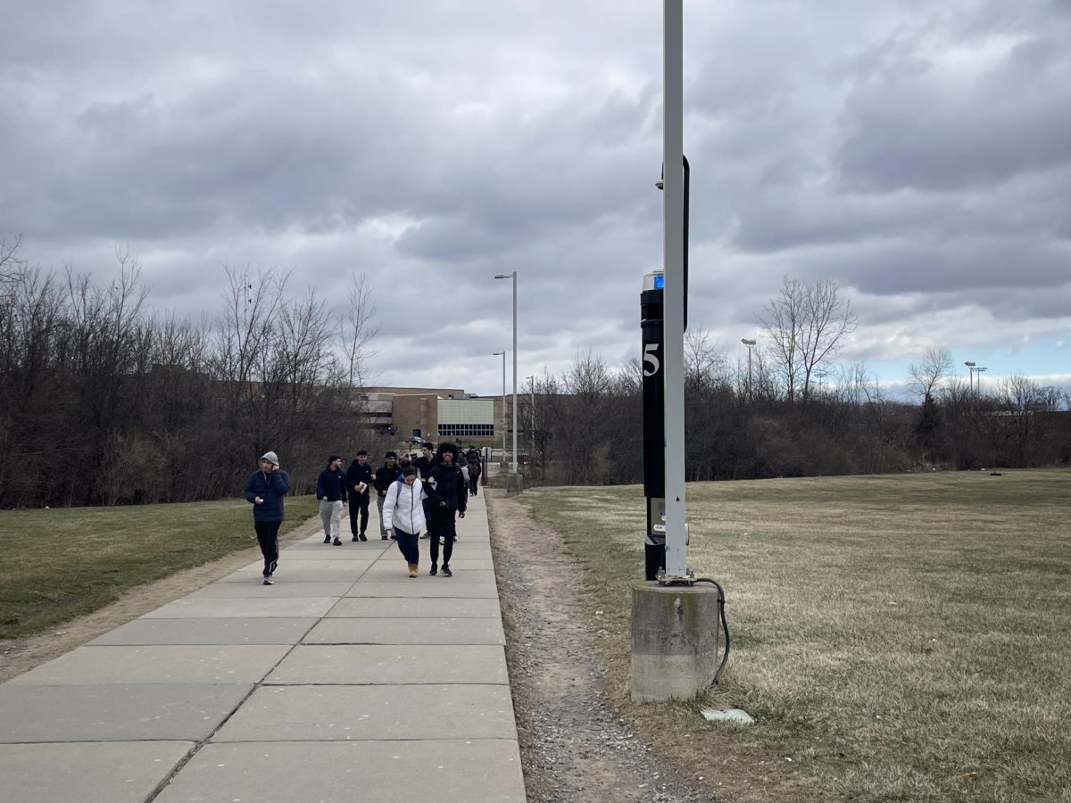 P-CEP students walk on the path between Plymouth High School and Salem High School beside an emergency alert station. March 23, 2026